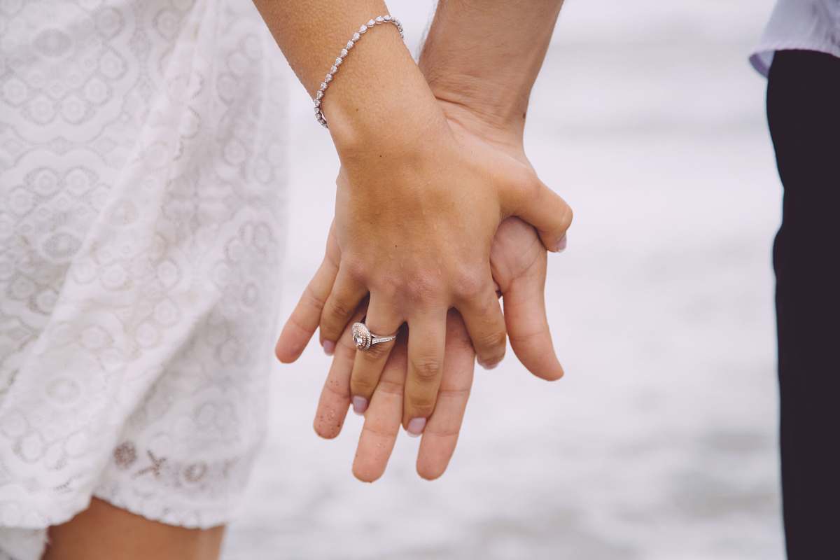 holding hands couple holding each hands grey